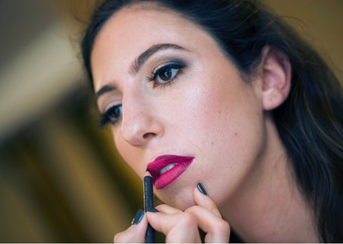 Bride applying lipstick, final touch-up with Glamour Girl makeup