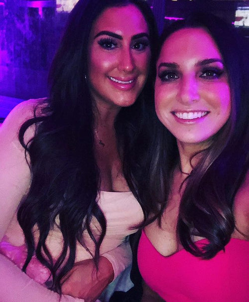 Two friends enjoying a night out in Chicago, showcasing their radiant Glamour Girl Airbrush Tans.