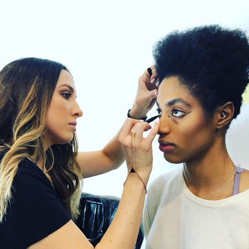 Model in a blue leather outfit on the NYFW runway with makeup by Glamour Girl Airbrush Tan.