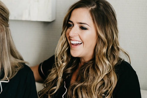Close-up of bridesmaid's makeup by Glamour Girl featuring a radiant smile and detailed eye makeup