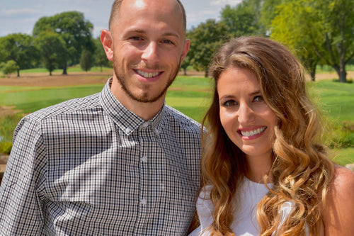 Couple making a toast during engagement photo shoot with Glamour Girl makeup