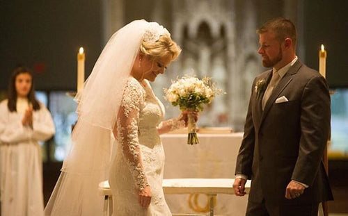 Bride and groom in a solemn church wedding ceremony with bride in Glamour Girl makeup