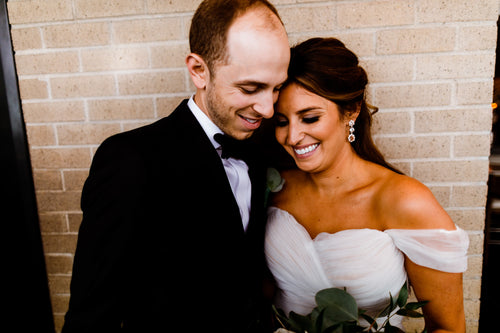 Romantic moment between couple with bride in Glamour Girl makeup