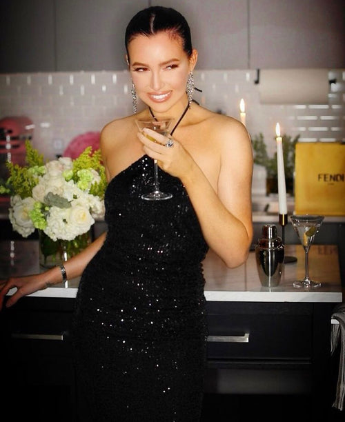Elegance at a Chicago soirée with a glamorous black dress complementing the Glamour Girl Airbrush Tan.