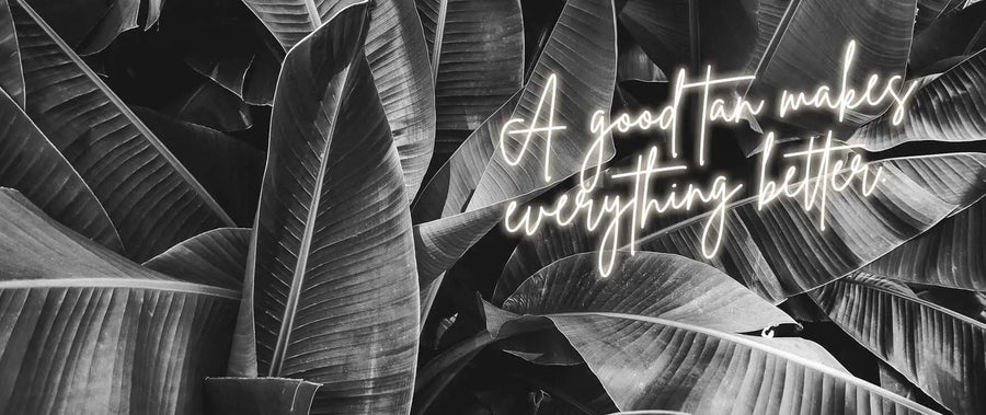 Black and white palm leaves with gold text: 'A Good Tan Makes Everything Better‘