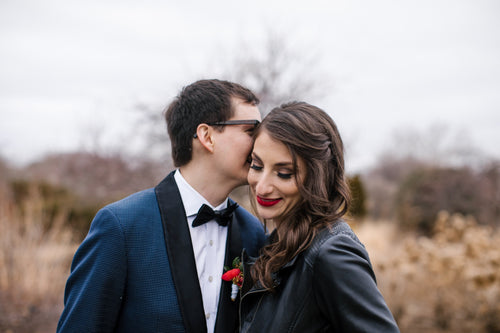 Bride and groom in outdoor winter scene with bridal makeup by Glamour Girl