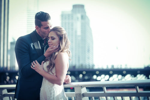Newlyweds sharing their first dance at city wedding, bride’s makeup by Glamour Girl