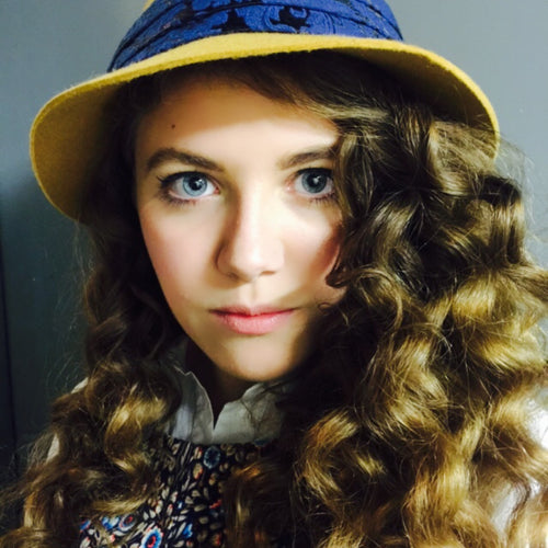 Vintage-inspired makeup look with curls and hat created by Glamour Girl Airbrush Tan in Chicago